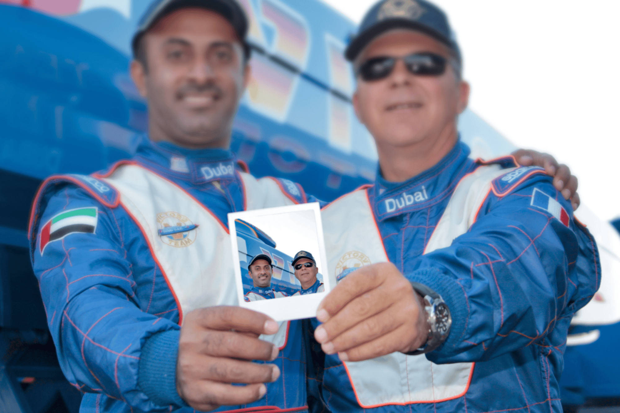 Two offshore racing pilots with a polaroid photo
