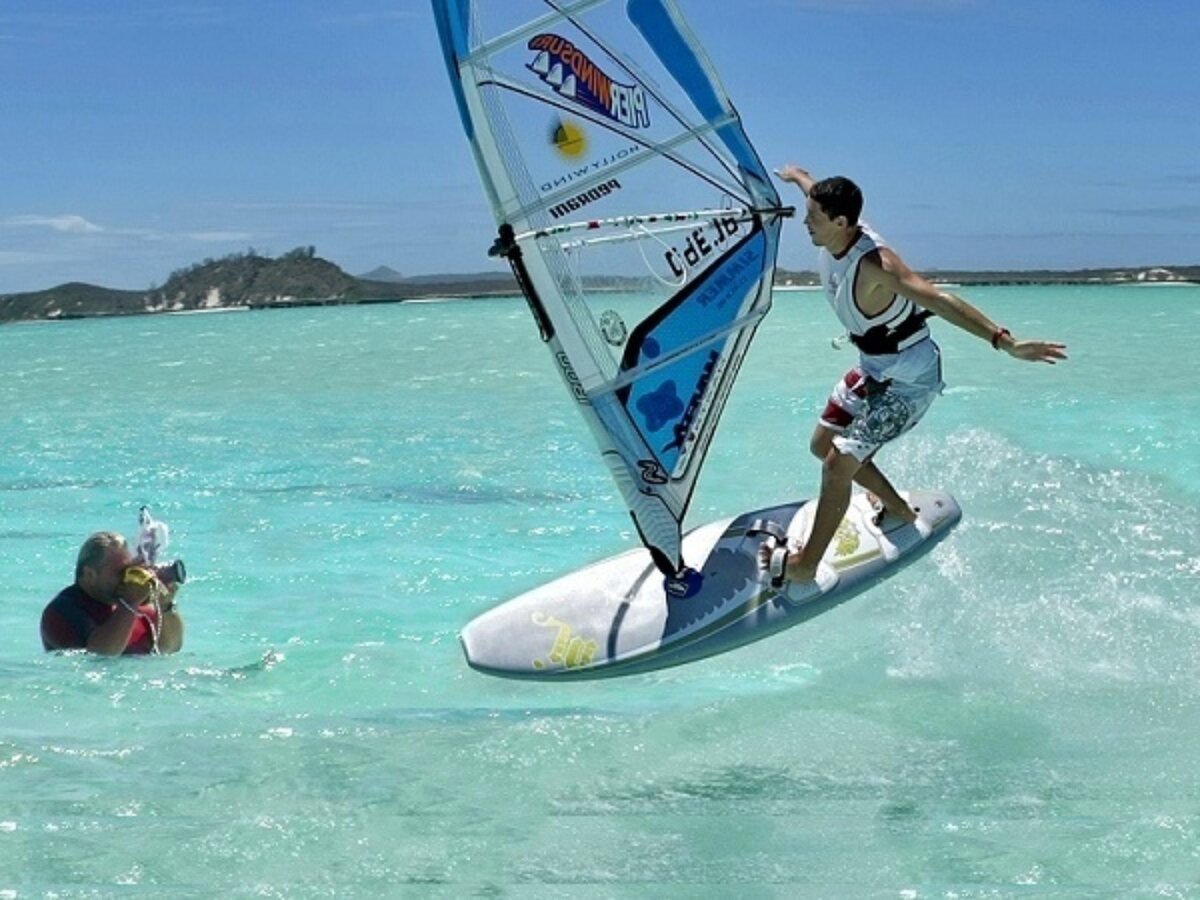 Raffaello Bastiani in the water photographing a windsurfer in action