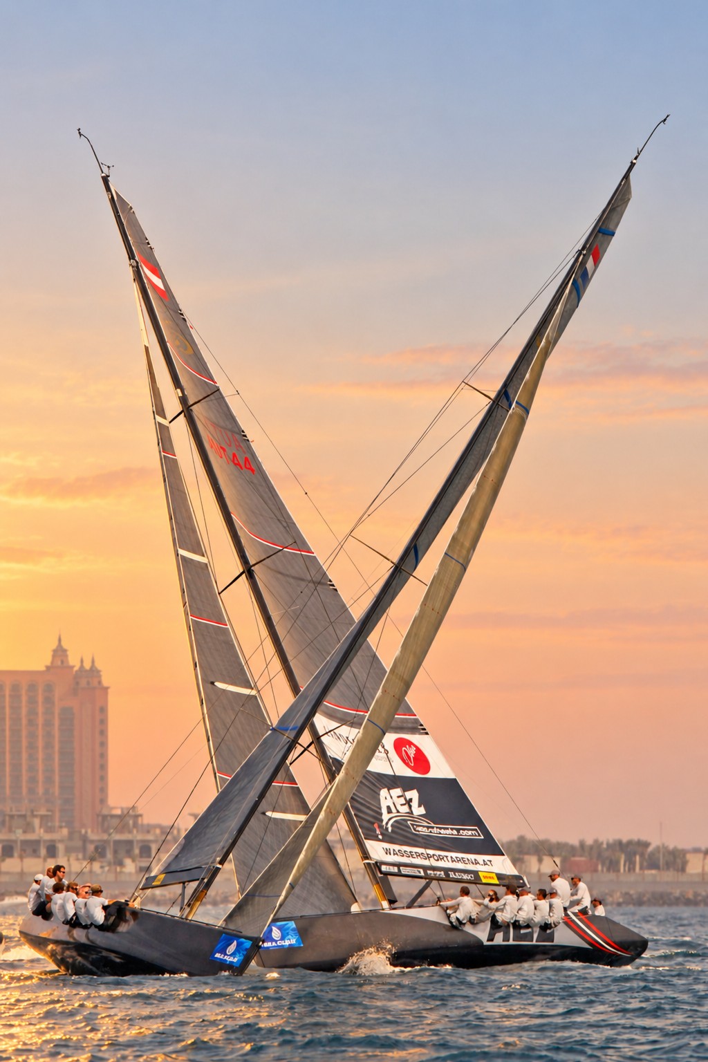 Crossing sailing yachts at sunset