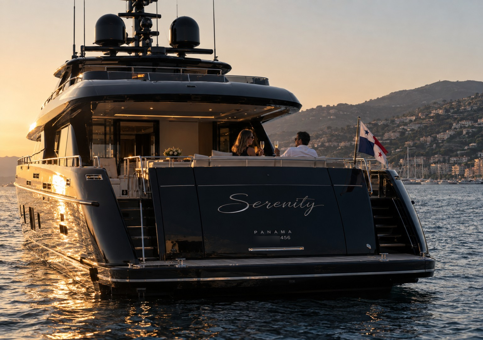 Yacht Serenity at sunset with guests on the aft deck