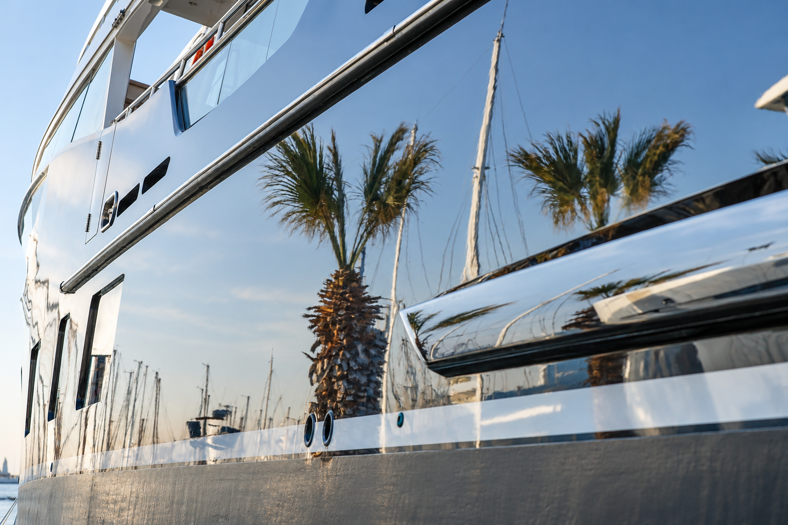 Palm trees reflected on the yacht hull
